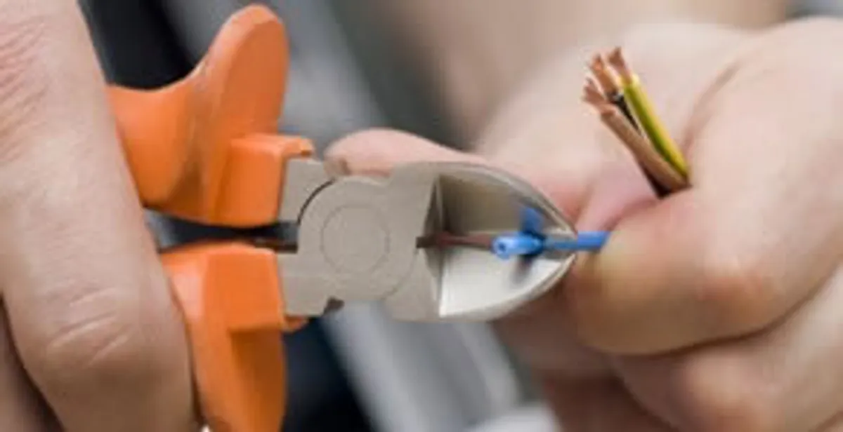 licensed electrician performing precise wire cutting and preparation during electrical service in Santa Rosa, CA
